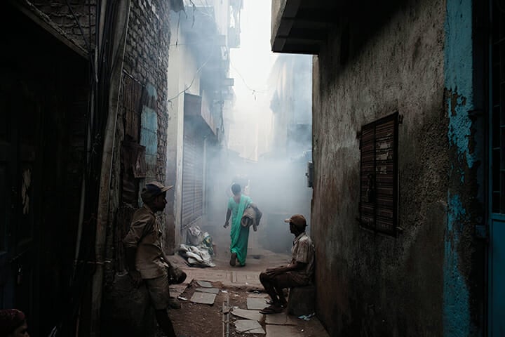 A woman walks through the Kumbharwada potting area of Dharavi in 2011.